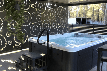 Decorative screening by a large hot tub